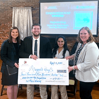 Student winners with faculty member holding large check