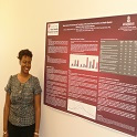 Woman standing next to an informational poster