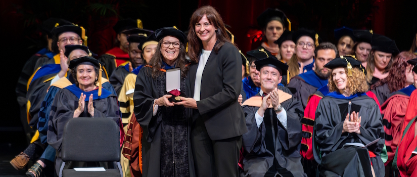 An alumni of the university accepting an achievement award