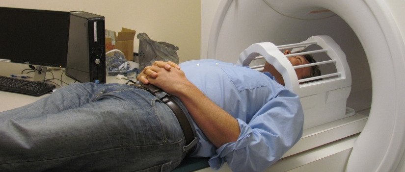 Man laying down about to enter an MRI machine