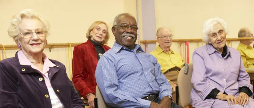 Group of elderly individuals sitting and posing