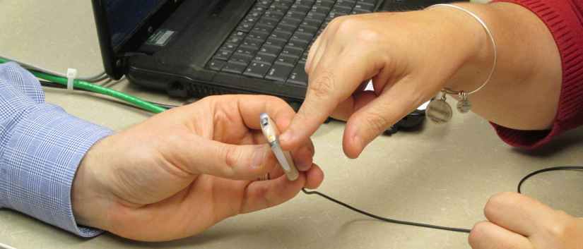 Close-up of hearing aid in hands