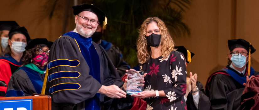 An alumni of the university accepting an achievement award