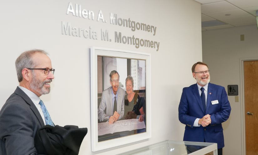Kenn Apel (left) and Dean Thomas Chandler reveal the portrait of Al and Marcia Montgomery