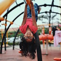 girl upside down on playground