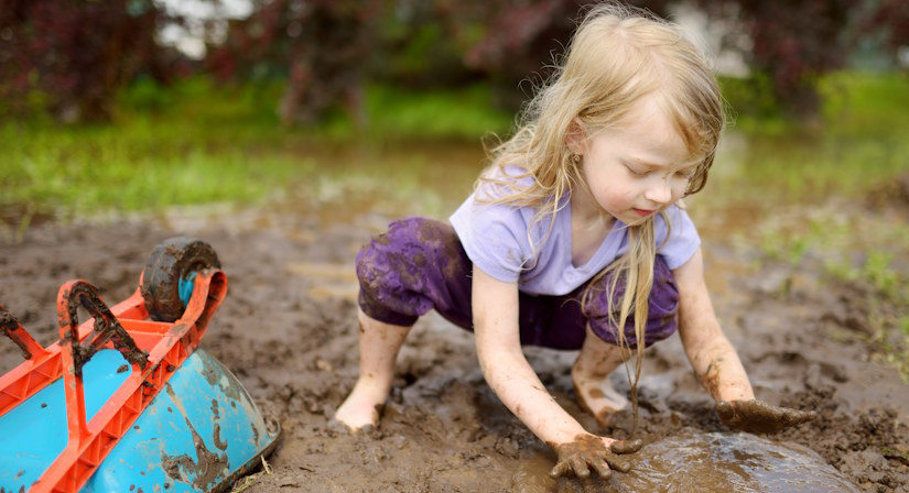 child playing in mud