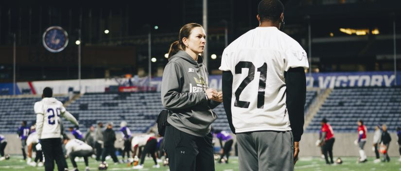 Rachel Sharpe talks to a player at practice