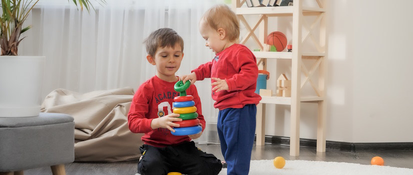 toddler older brother playing