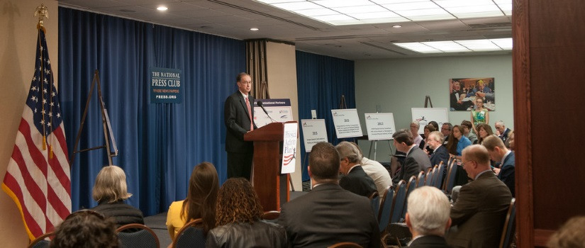 Man standing in front of a podium during a press release