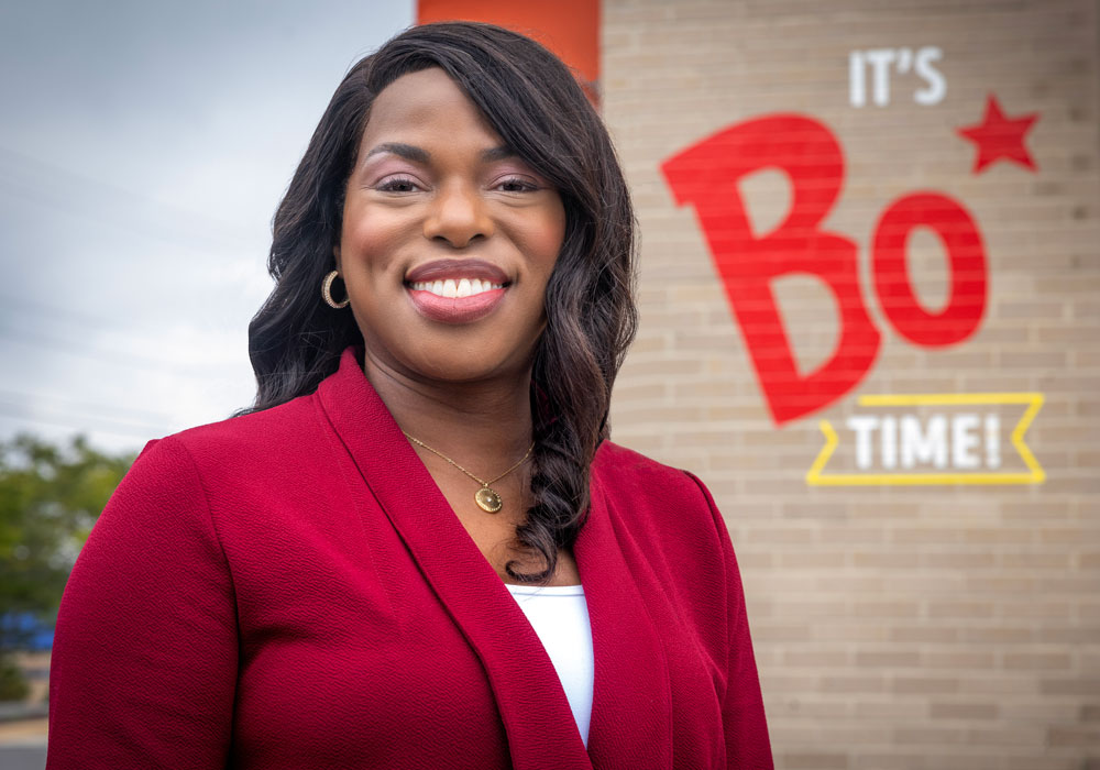 Stacey McCray smiles for the camera standing in front of a Bojangles.