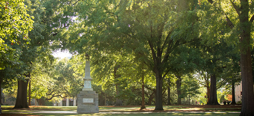 the maxcy monument surrounded by green trees on the UofSC horseshoe