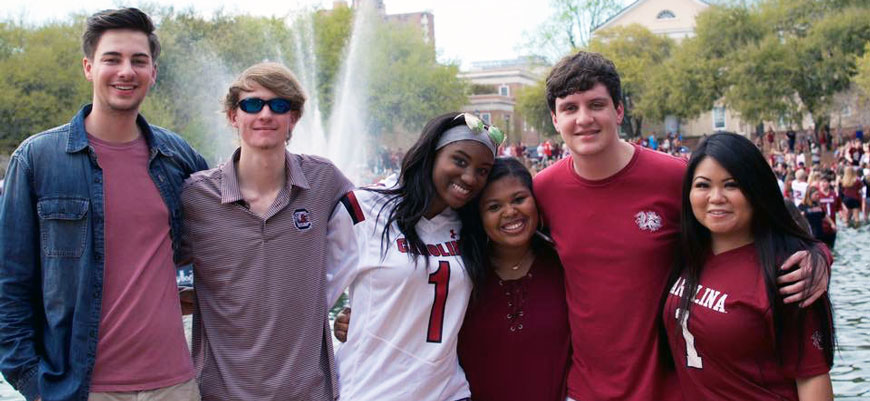 Amelia Wilks and friends celebrate at the fountain at Thomas Cooper Library