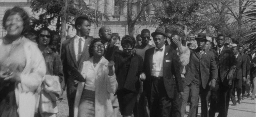 black and white photo of students marching at SC State House in 1961