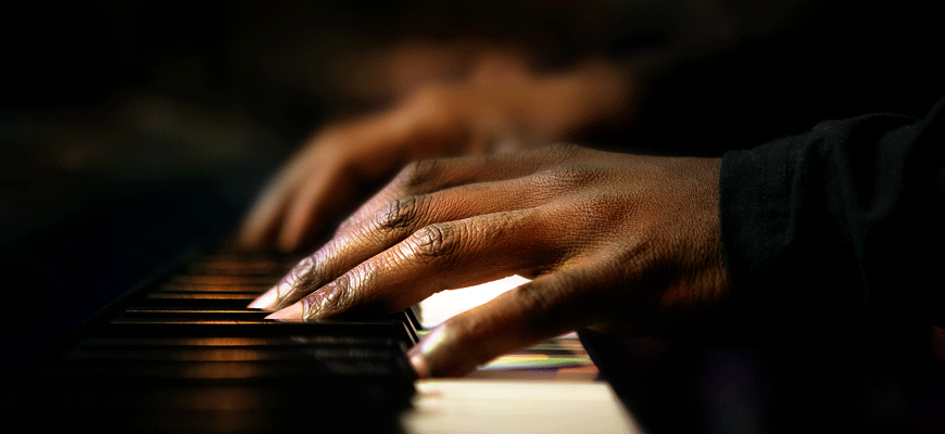 photo illustration of Black hands playing a piano