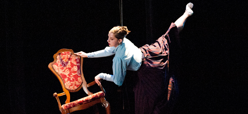 Woman dancing with chair on stage