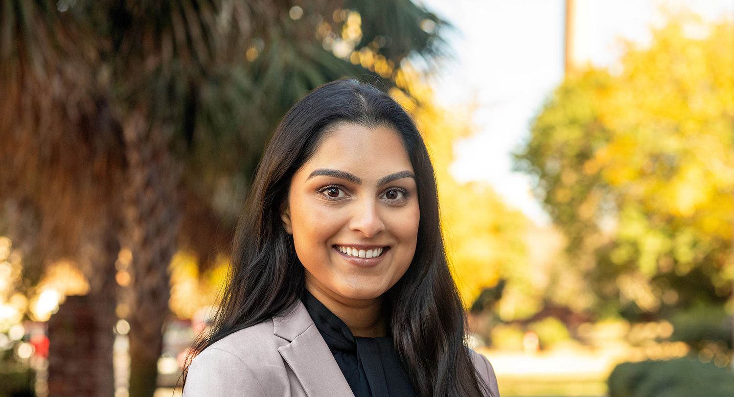 Poorva Dalvi standing outside.