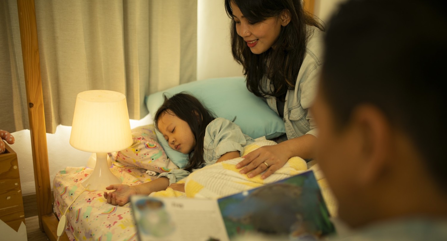 child sleeping in bed