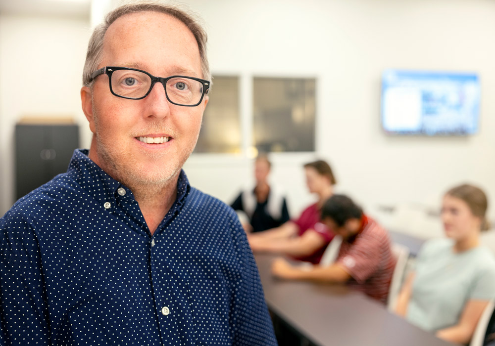 John Grady stands outdoors on USC campus