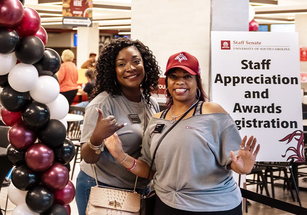 Two staff members pose in the Russell House during Staff Appreciation and Awards Day
