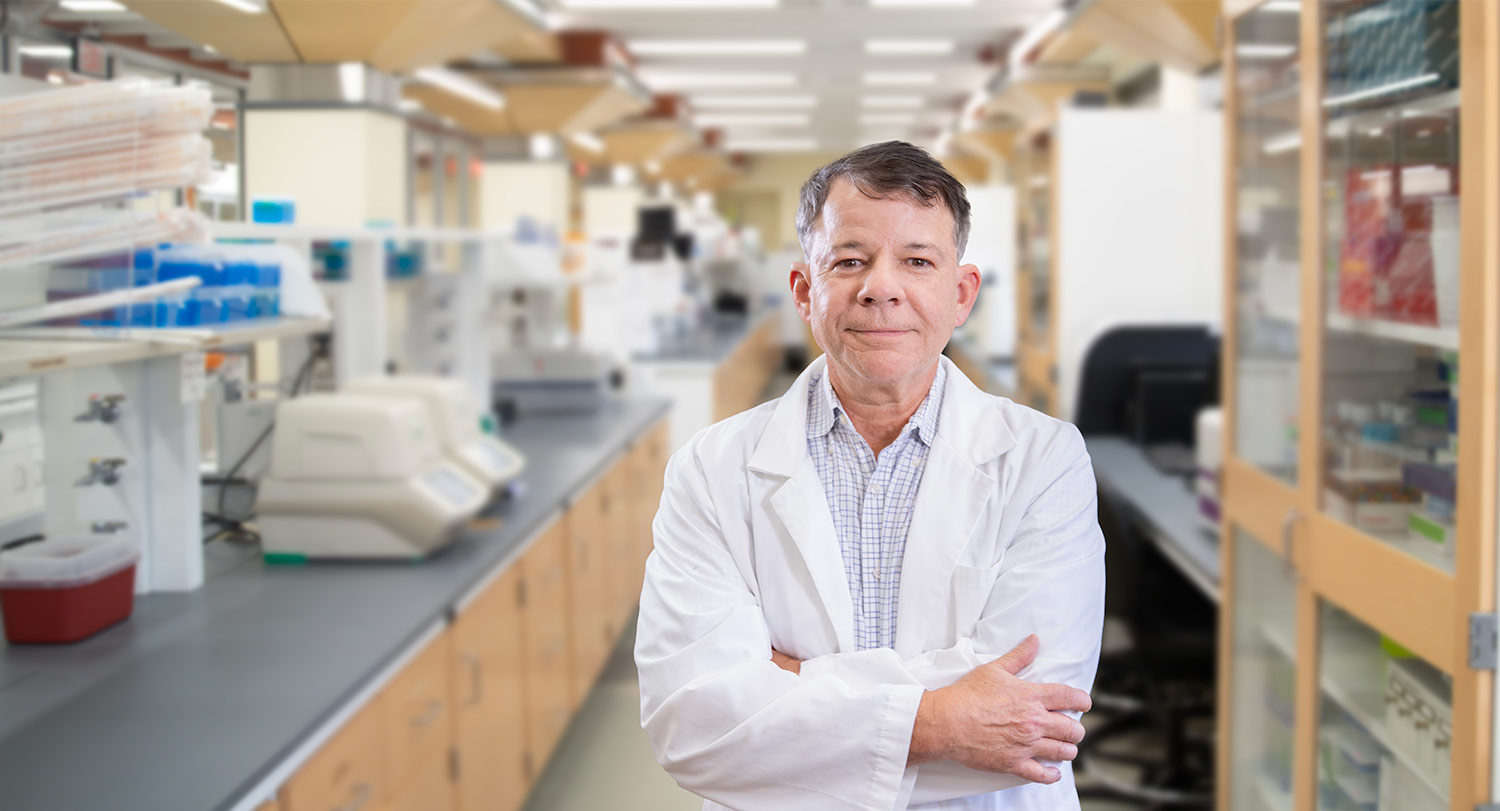 Man in white coat in lab