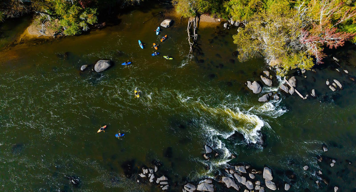 Overhead view of kayakers on river.