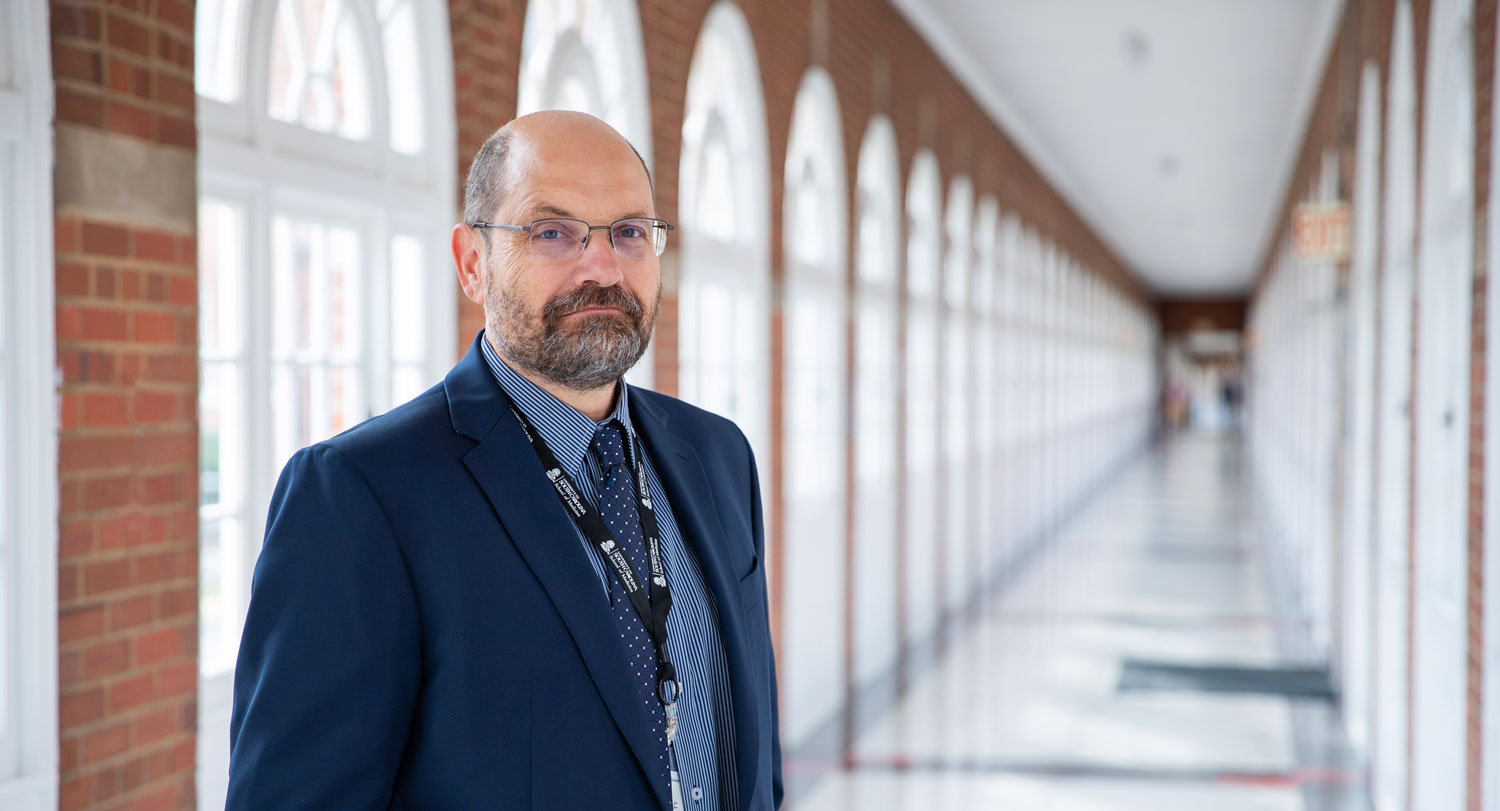 Paul Toriello stands in a hallway.