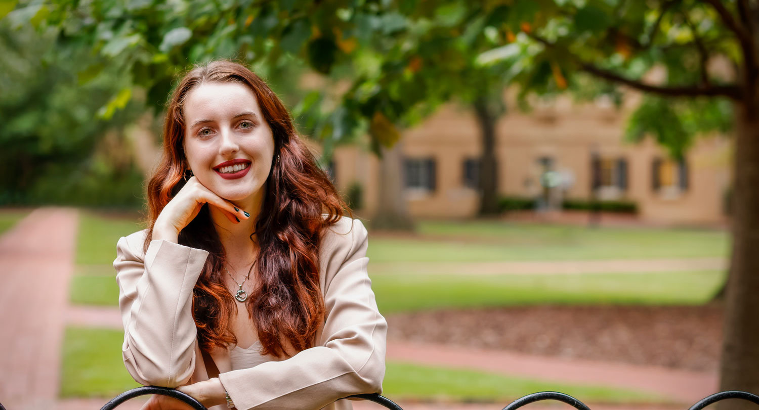 Ella Tocci leaning on a gate in the Horseshoe.