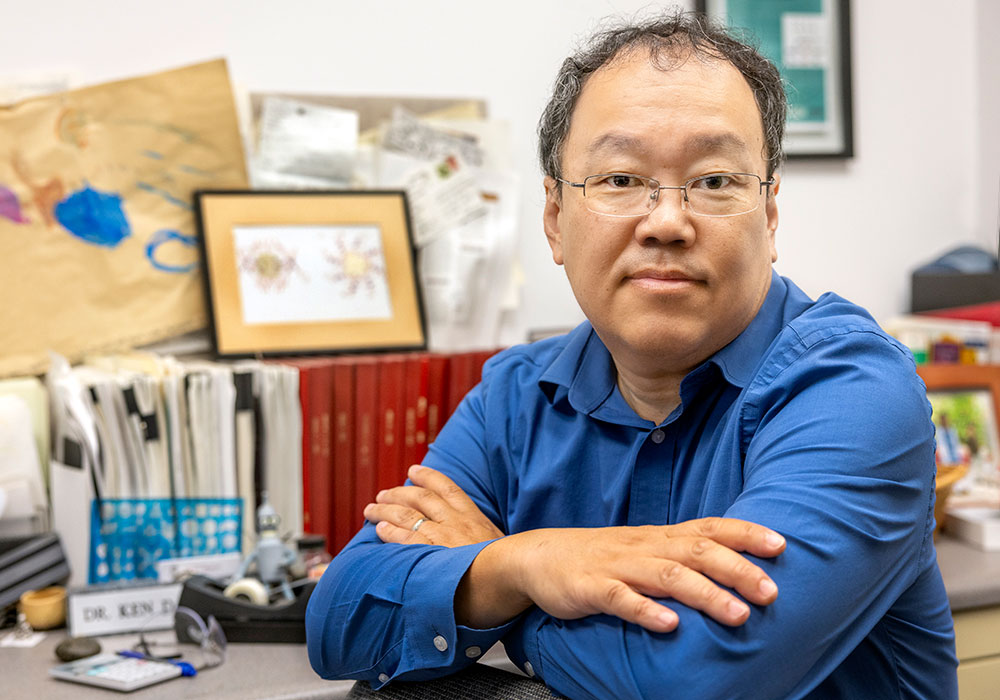 Ken Shimizu sits at his desk