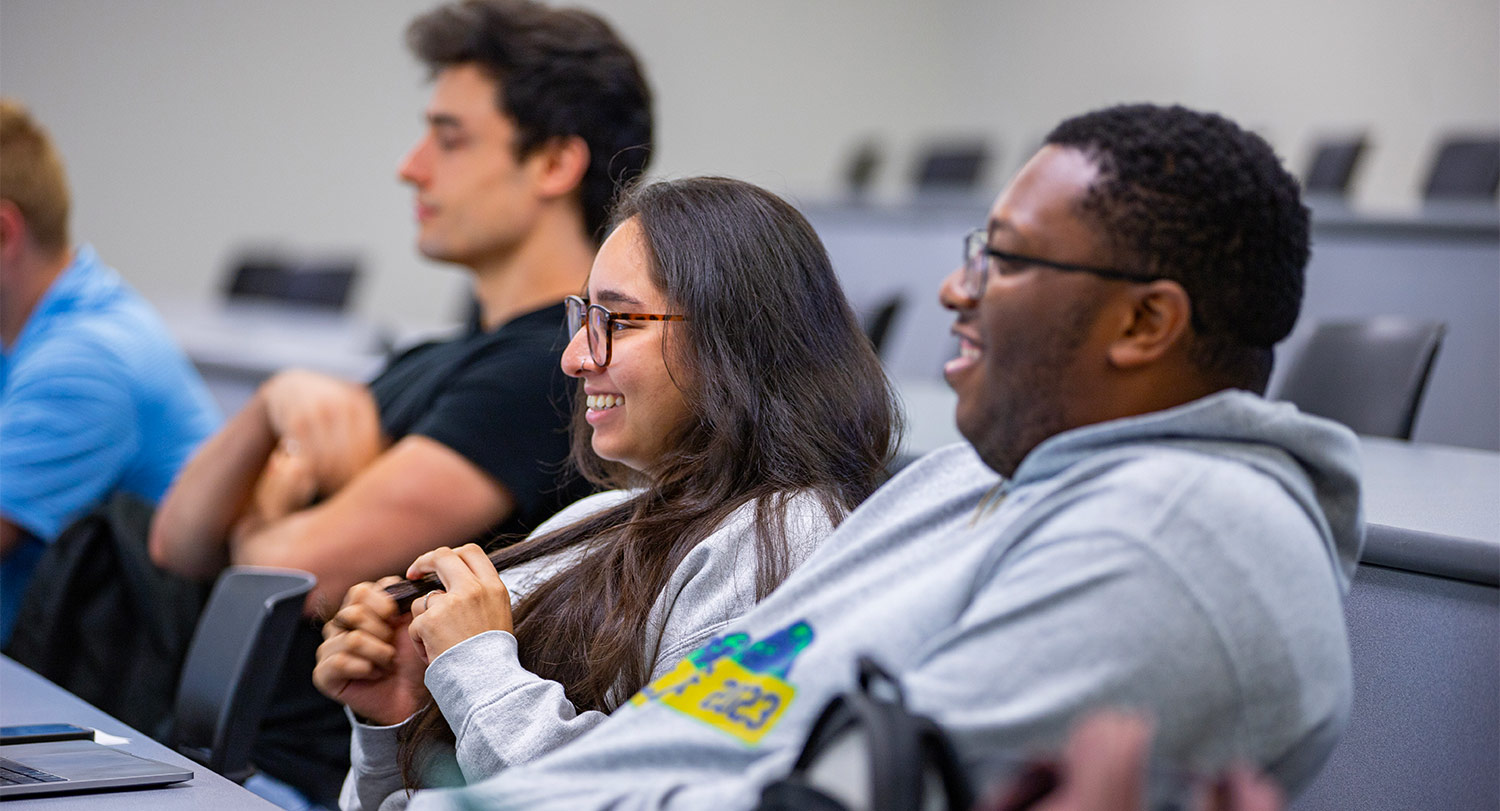 Three students smiling in class
