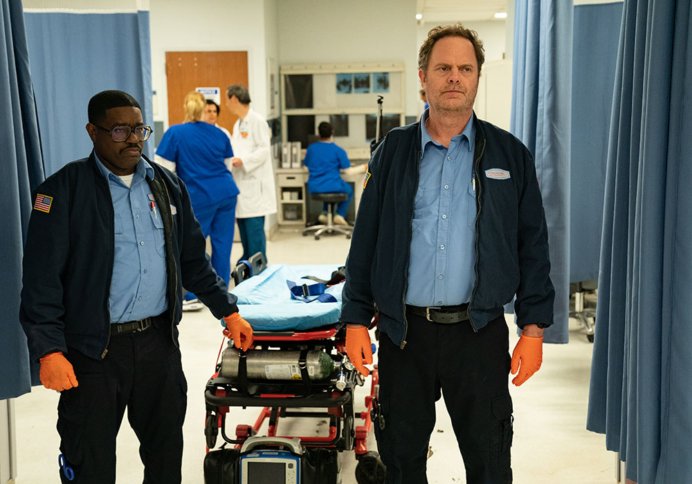 A still from the Code 3 movie of actors Lil Rel Howery and Rainn Wilson standing in a hospital