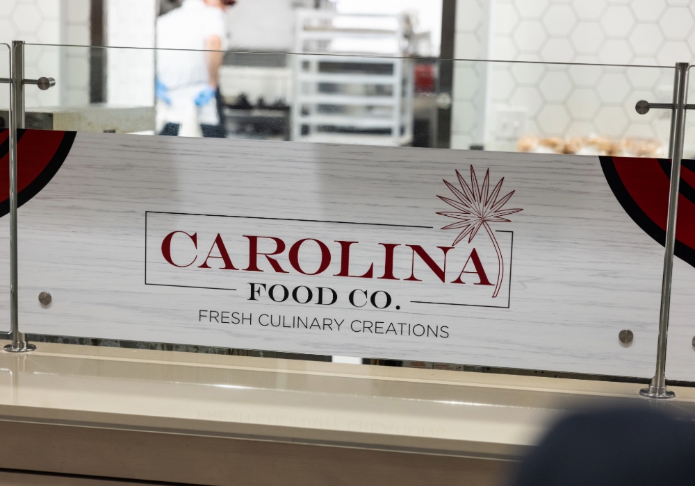 Logo of Carolina Food Co. on a glass wall in the dining hall.