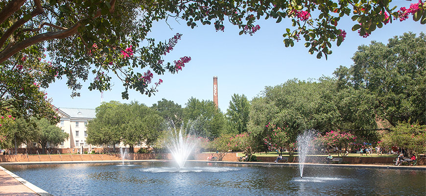 The USC smokestack rises over the Thomas Cooper library fountain on a sunny day