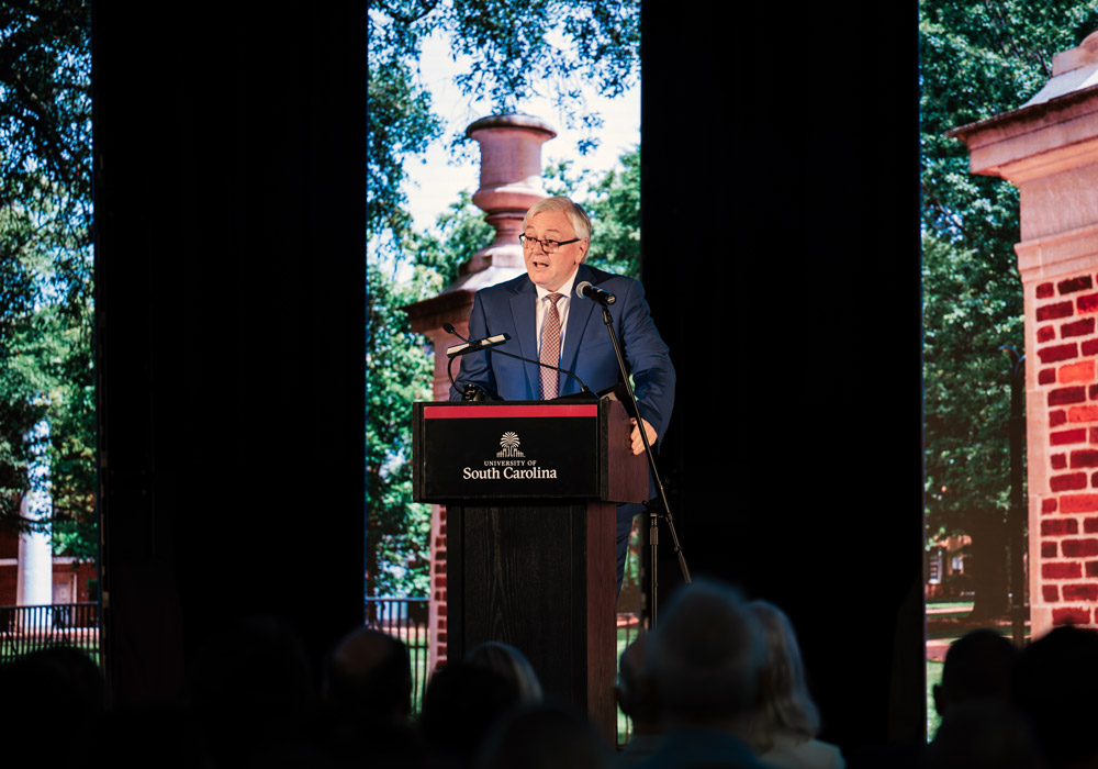 man stands behind podium with the words university of south carolina on it