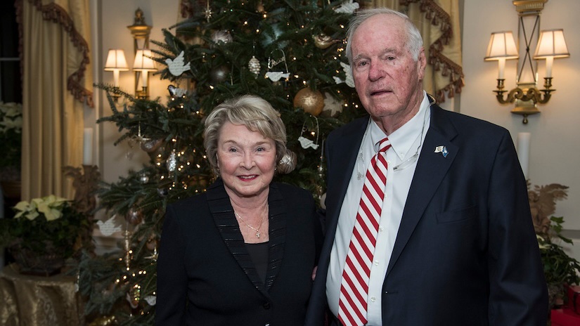 eddie and kay floyd standing in front of a christmas tree