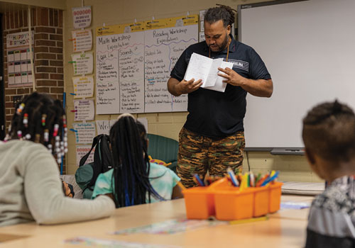 Langston Moore speaks to a classroom