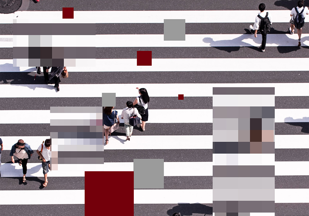 Ariel view of people on a crosswalk with parts of the image turning into large pixel blocks.