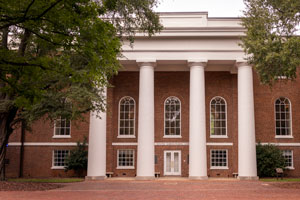 brick building with four white columns
