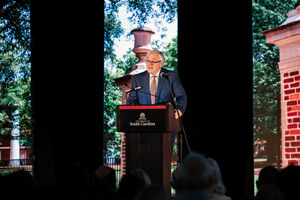 man stands at a podium with the logo of the university of south carolina on it