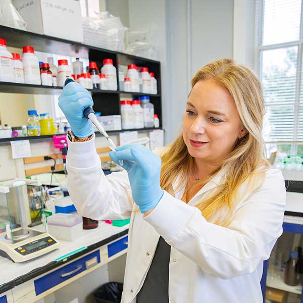 Woman in white coat in lab/