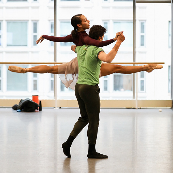 Dancers in studio perform a lift 