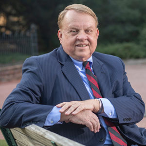 College of Arts and Sciences Dean Lacy Ford sits on a bench