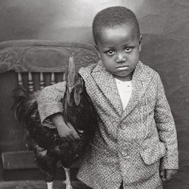 little boy with his pet chicken