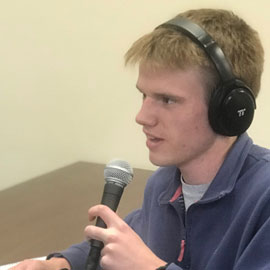 Student with podcasting microphone