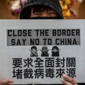 protester holds sign calling to close the border