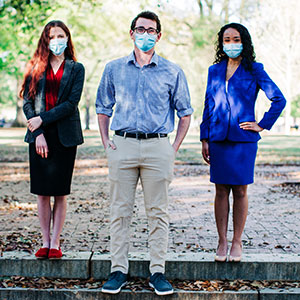 two female and one male student wearing masks