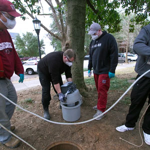 researchers sample wastewater