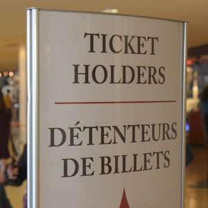 Sign in lobby of a building that says ticket holders