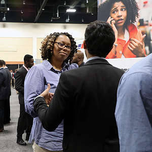 Recruiter speaking to student at a career fair
