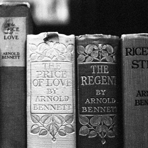 old books on a library shelf in a black and white photo