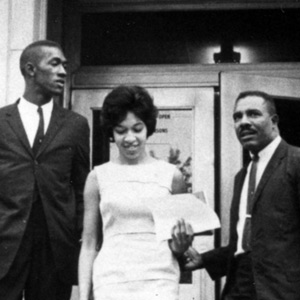 archival image of three Black students on the steps of USC's administration building after enrolling in 1963